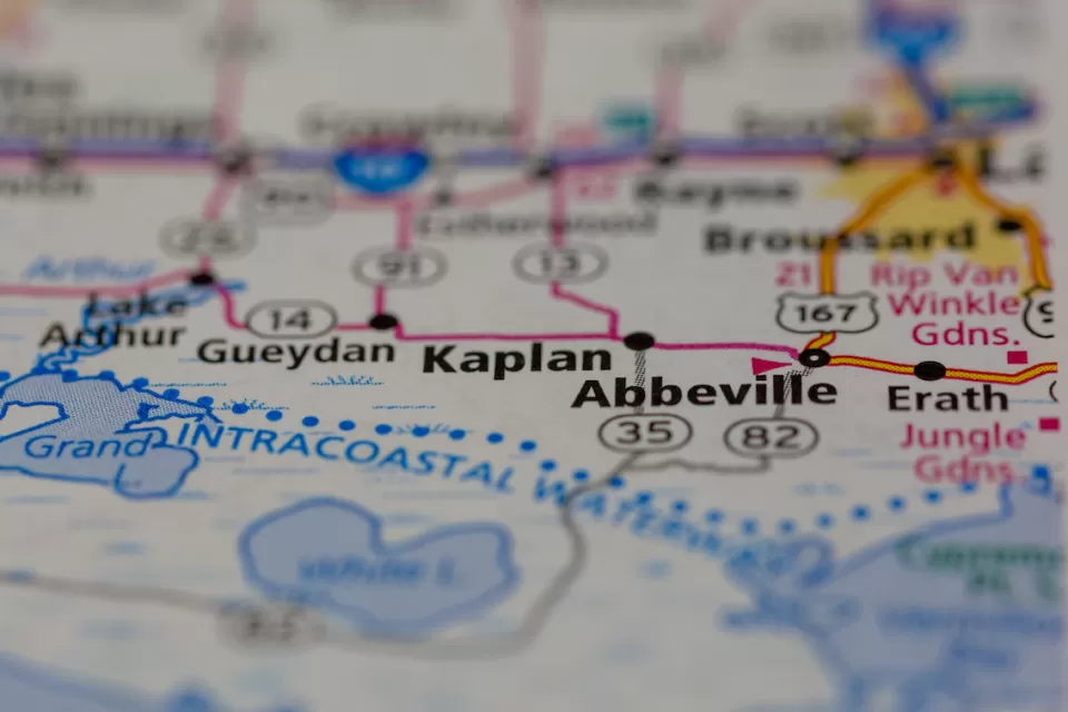 A map depicting a row of cities long a highway, focusing on the city of Kaplan with surrounding cities blurred.